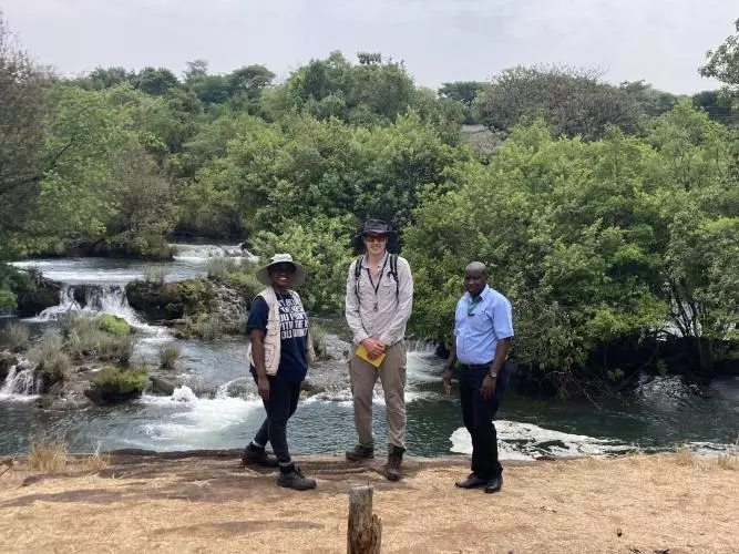 Dr Tobermory Mackay-Champion standing  Mrs Mulenga Chanda (co-author), and Mr Matthews (